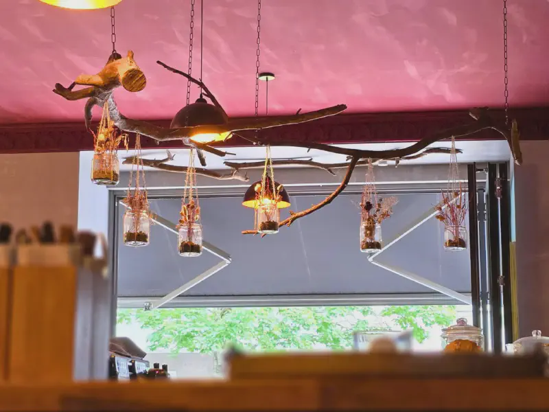 Branch with hanging jars full of dried flowers
