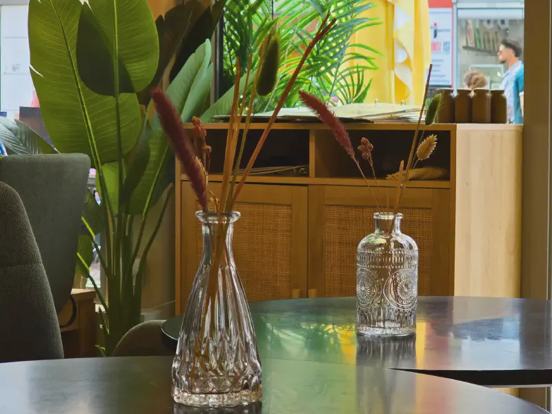 Dried flowers in glass vases on a dark table