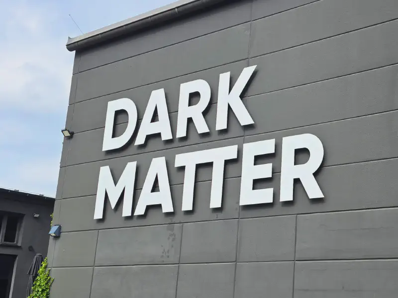 DARK MATTER lettering on the grey facade