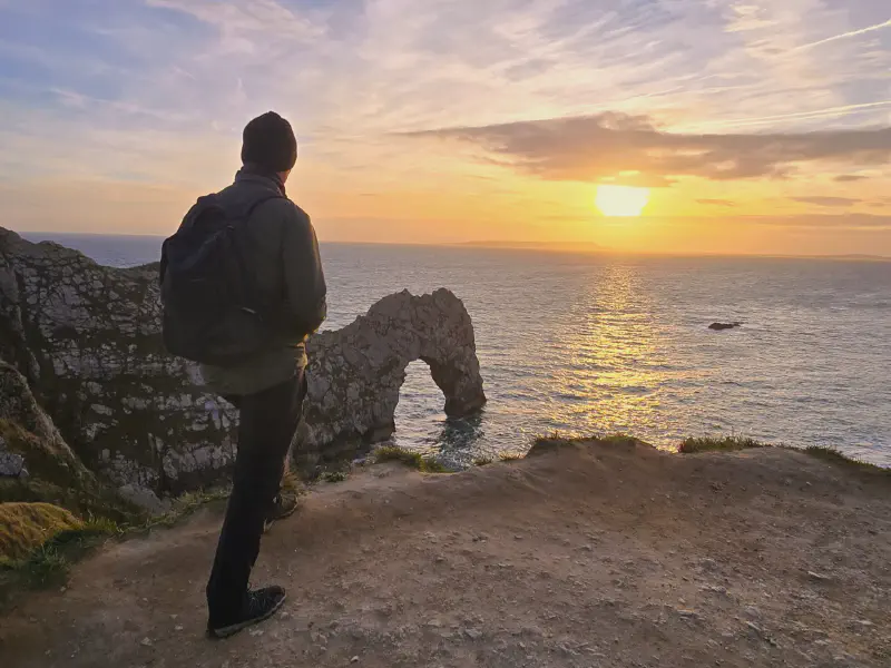 Oli looking out at Durdle Door at sunset