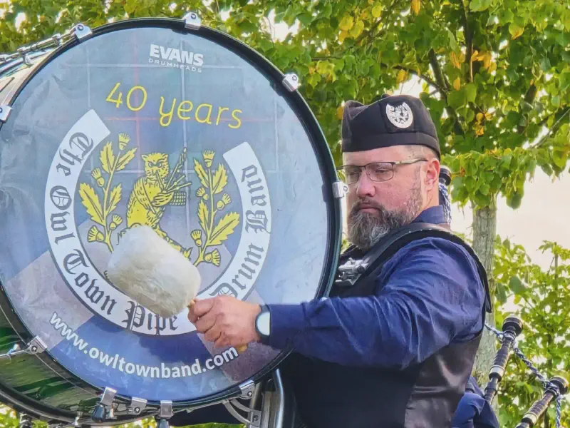 The bass drummer of the Owl Town Pipe Band