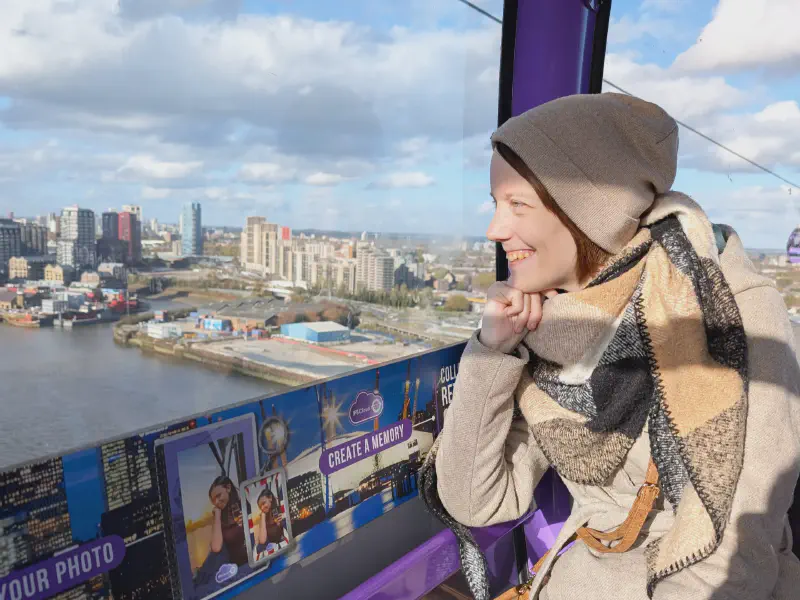 Gina sitting in the cable car, enjoying the view over London.