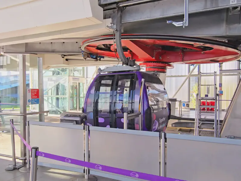The London Cable Car station with a purple gondola.