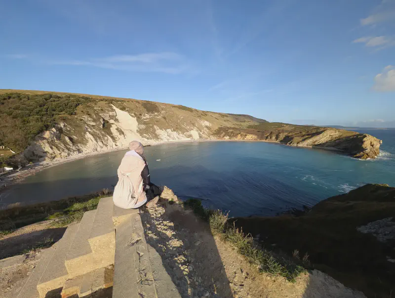 Gina sitting at Lulworth Cove Viewpoint